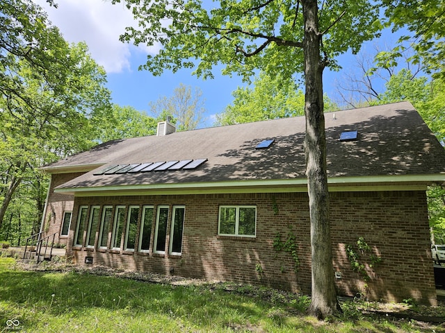 4257 Tattersall Dr, Plainfield, IN 46168 - view of property exterior featuring brick siding, a chimney, and a shingled roof