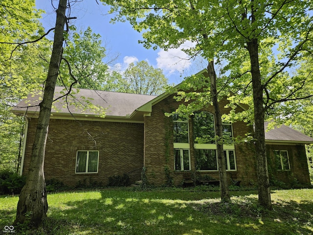 4257 Tattersall Dr, Plainfield, IN 46168 - view of front of house with brick siding, a front yard, and roof with shingles