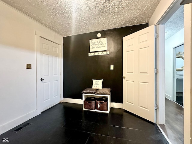 foyer featuring a textured ceiling