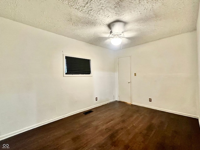 unfurnished room with a textured ceiling, ceiling fan, and dark wood-type flooring