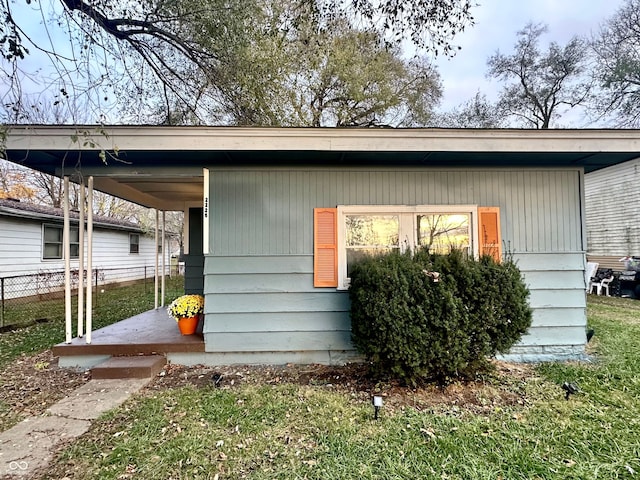 exterior space featuring a lawn and a porch