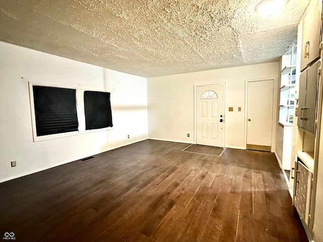 interior space featuring a textured ceiling and dark hardwood / wood-style floors