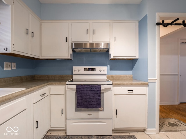 kitchen featuring white range with electric cooktop, white cabinetry, and light wood-type flooring