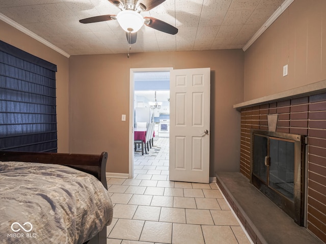 bedroom featuring ceiling fan with notable chandelier, a brick fireplace, crown molding, and light tile patterned flooring