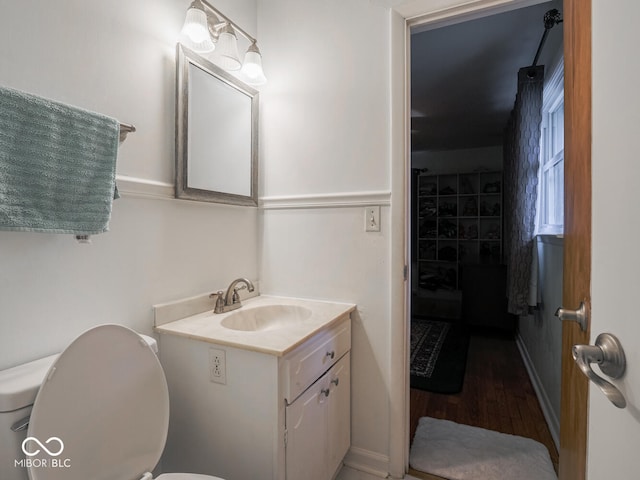 bathroom featuring vanity, hardwood / wood-style flooring, and toilet