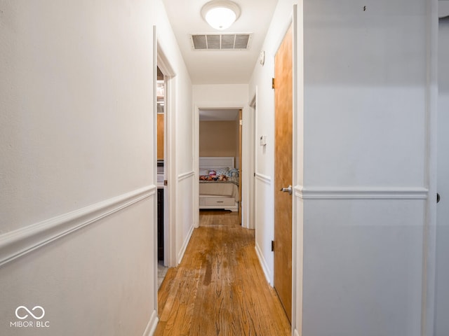 hallway with light hardwood / wood-style flooring