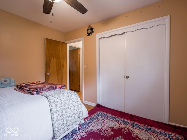 bedroom featuring ceiling fan and a closet