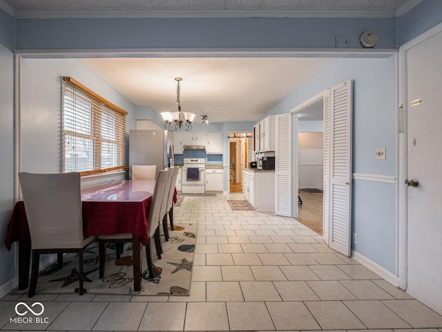 tiled dining room with crown molding and a notable chandelier