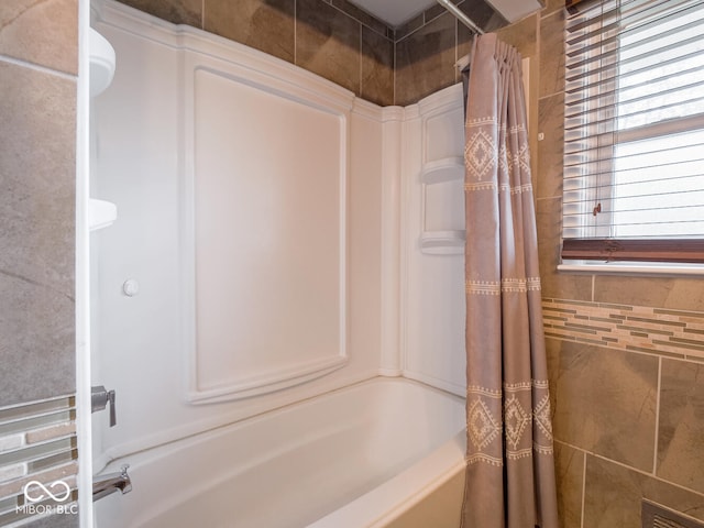 bathroom featuring shower / tub combo with curtain