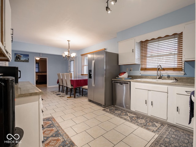 kitchen with white cabinets, stainless steel appliances, and sink