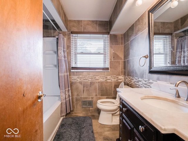 full bathroom with vanity, tile patterned flooring, toilet, tile walls, and shower / tub combo with curtain