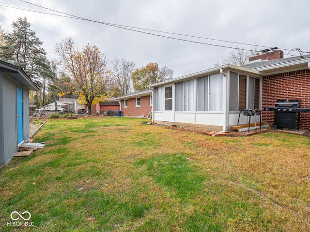 view of yard featuring a sunroom