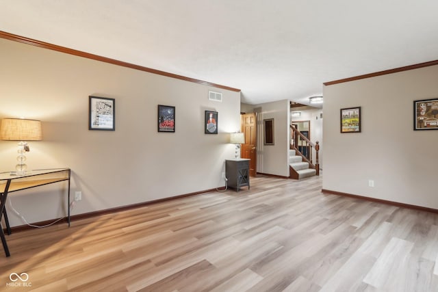 interior space with crown molding and light hardwood / wood-style floors