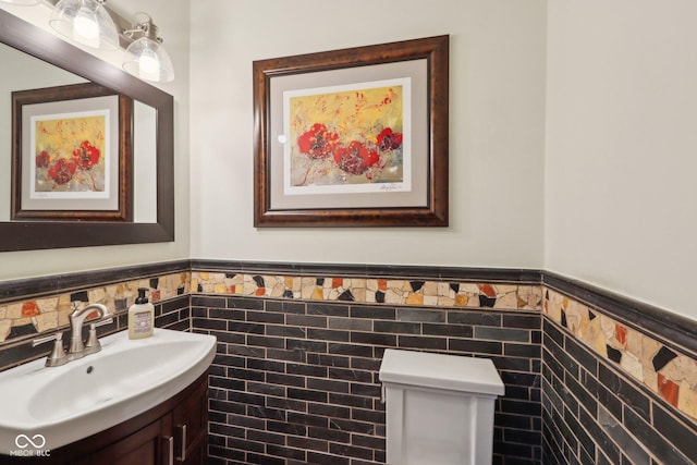 bathroom featuring tile walls and sink