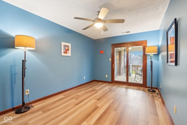 spare room with light wood-type flooring and ceiling fan