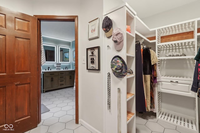 spacious closet with sink and light tile patterned floors