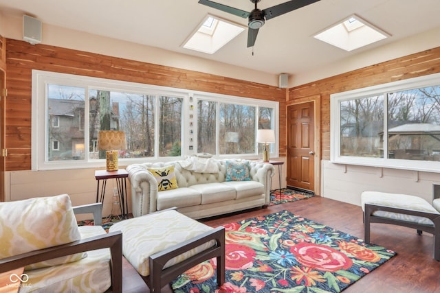 sunroom featuring ceiling fan and a skylight