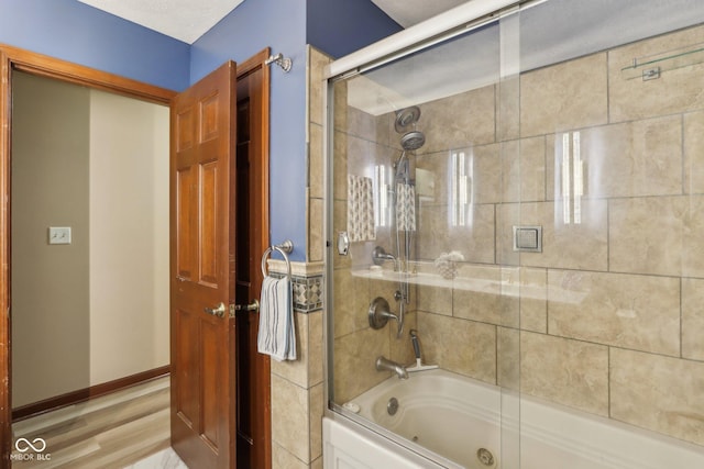 bathroom with hardwood / wood-style floors and enclosed tub / shower combo