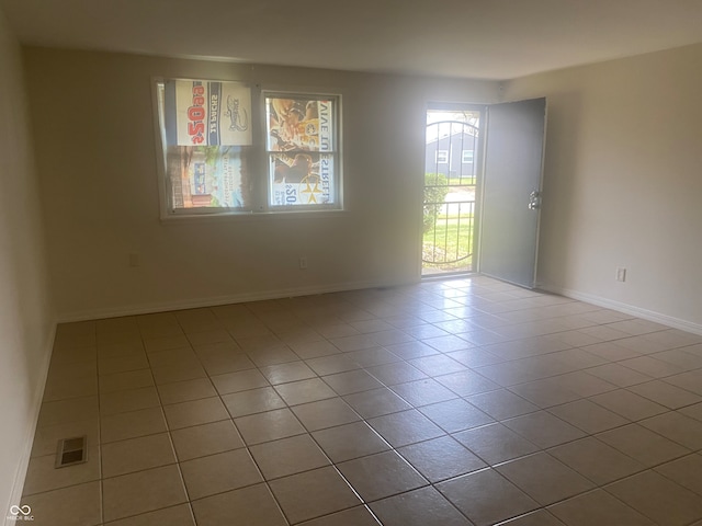 unfurnished room with light tile patterned floors