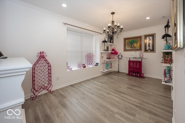 misc room featuring an inviting chandelier, ornamental molding, and hardwood / wood-style flooring