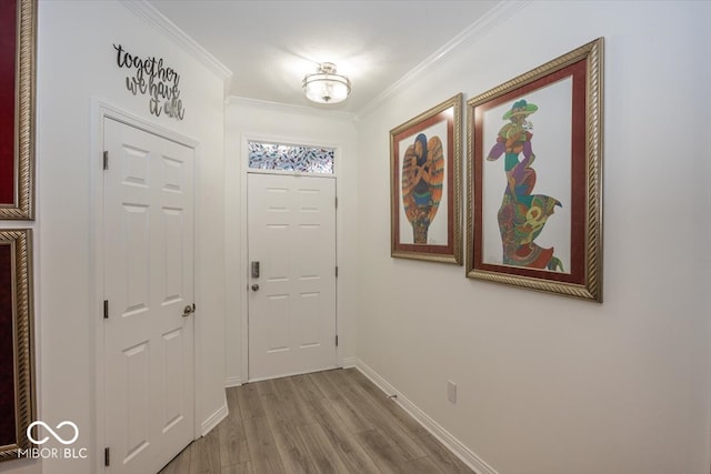 entryway featuring hardwood / wood-style floors and ornamental molding