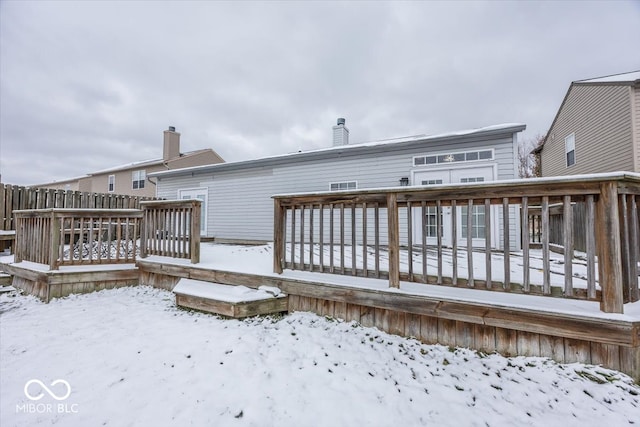 snow covered property featuring a deck