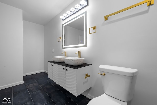 bathroom featuring tile patterned floors, vanity, and toilet