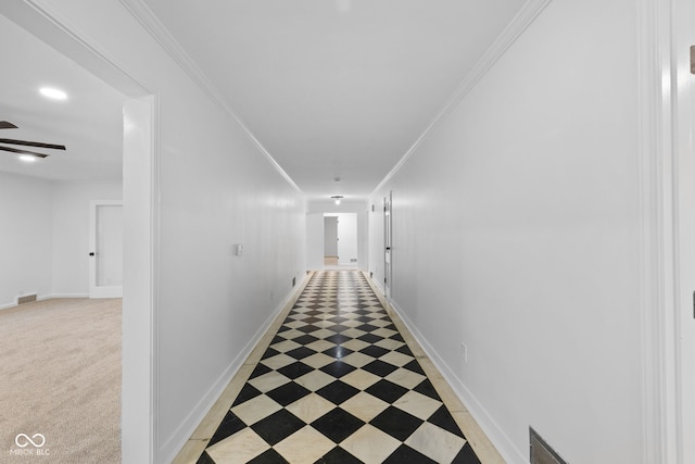 corridor featuring ornamental molding and light carpet