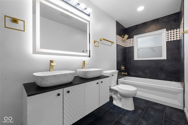 full bathroom with toilet, vanity, tile patterned floors, and tiled shower / bath