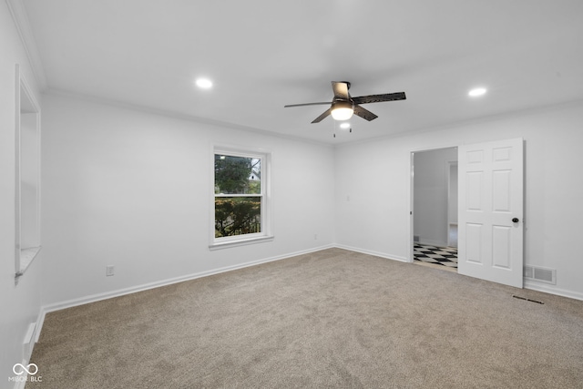 empty room featuring ceiling fan, carpet floors, and ornamental molding