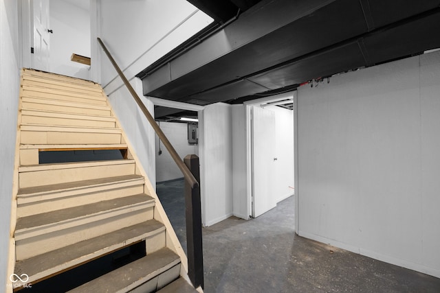 stairway featuring concrete flooring