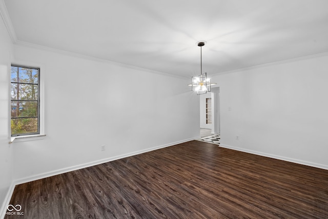 spare room with wood-type flooring, crown molding, and a notable chandelier