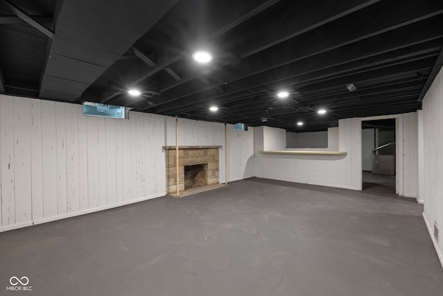 basement with a stone fireplace