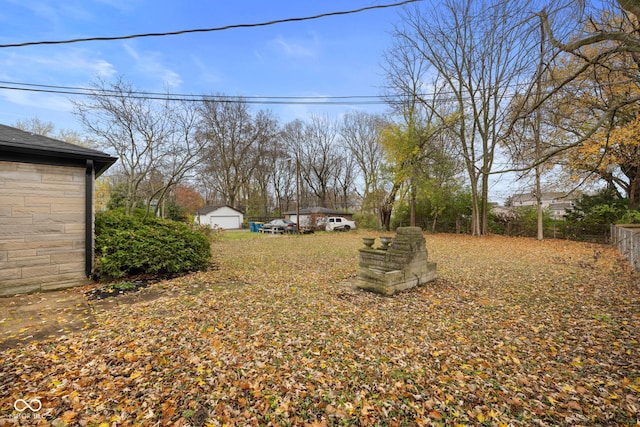 view of yard featuring a garage and an outdoor structure