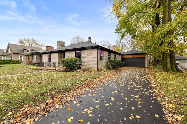 view of property exterior featuring a garage and a lawn