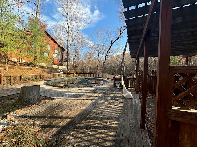 wooden deck featuring a covered pool