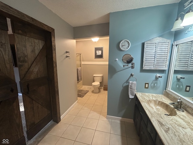 bathroom with tile patterned flooring, vanity, toilet, and a textured ceiling