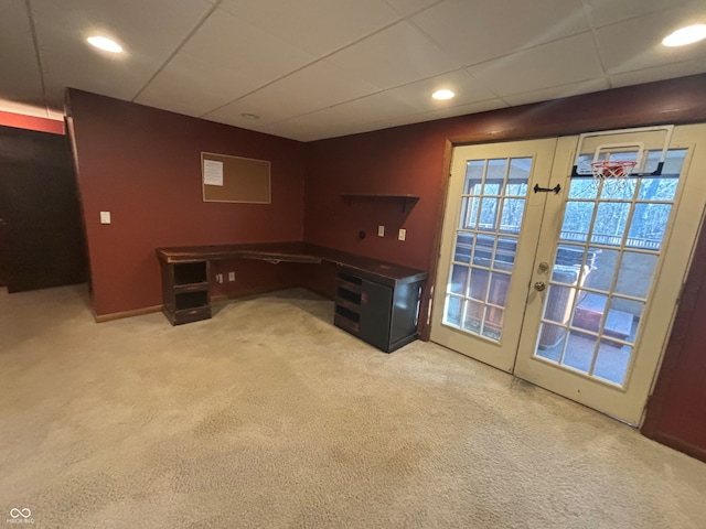 unfurnished office featuring french doors and light colored carpet