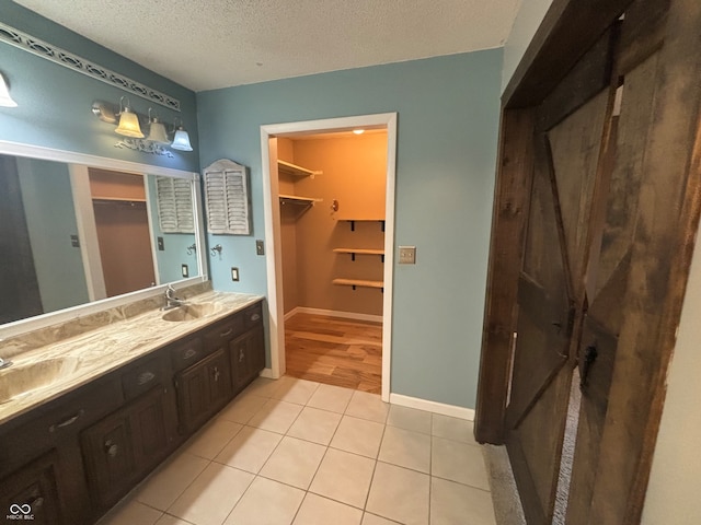 bathroom featuring vanity, a textured ceiling, and tile patterned floors