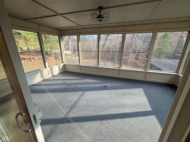 unfurnished sunroom featuring a paneled ceiling