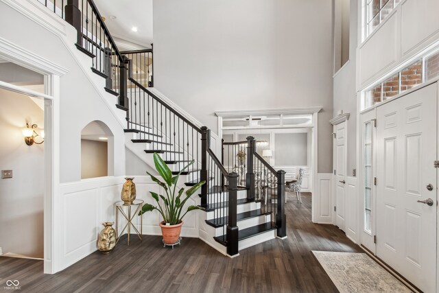 entrance foyer with dark wood-type flooring and a high ceiling