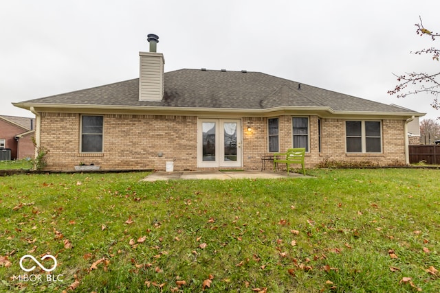 back of house featuring a patio and a lawn