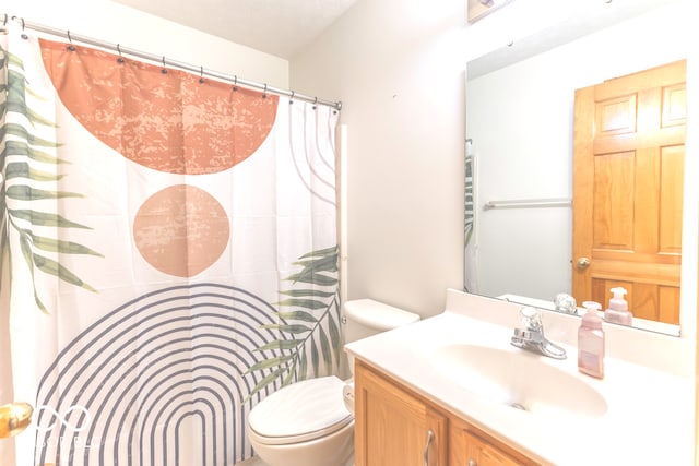 bathroom featuring vanity, toilet, and a textured ceiling