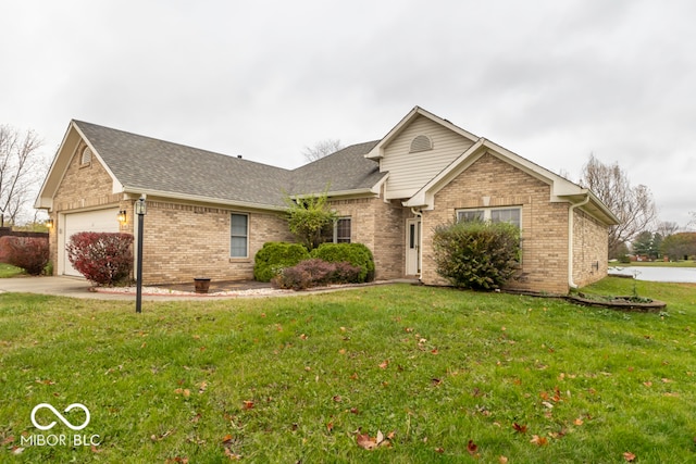 view of front of home with a front yard and a garage