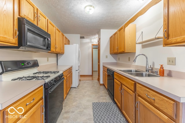 kitchen with sink, black appliances, and a textured ceiling