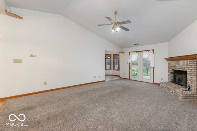 unfurnished living room featuring ceiling fan, a fireplace, carpet floors, and lofted ceiling