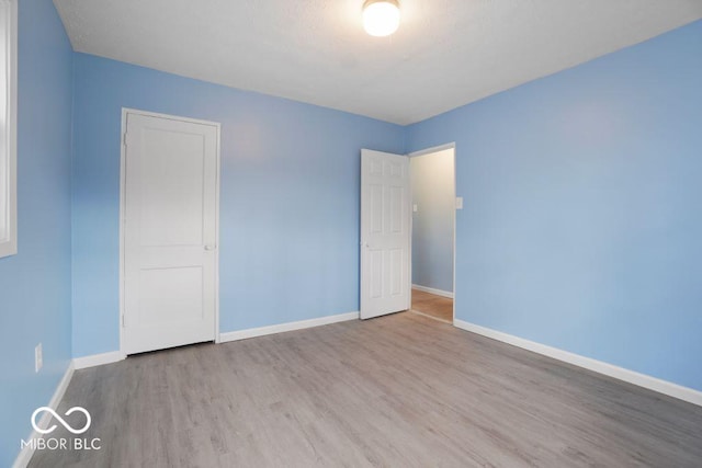 spare room with light hardwood / wood-style floors