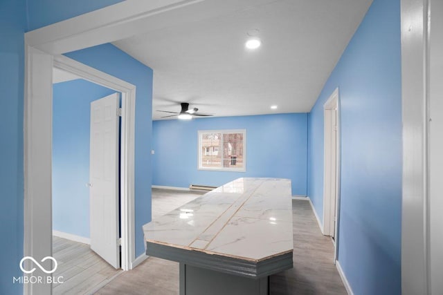 hall featuring a baseboard radiator and light wood-type flooring