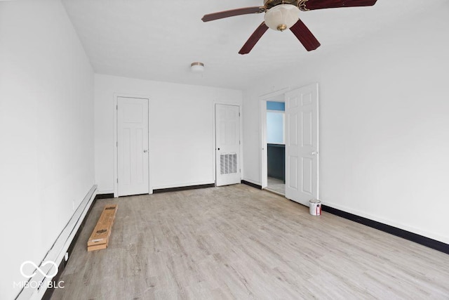 spare room featuring ceiling fan, light hardwood / wood-style floors, and a baseboard radiator