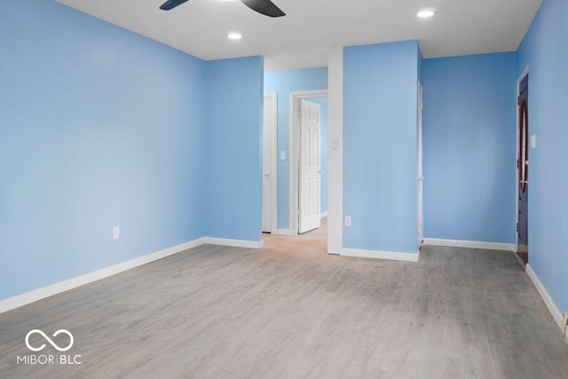 spare room with ceiling fan and hardwood / wood-style floors